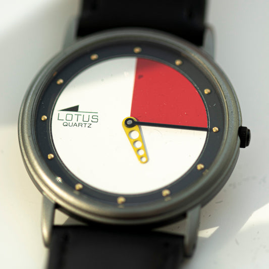 Watch with a red and white face on a white background