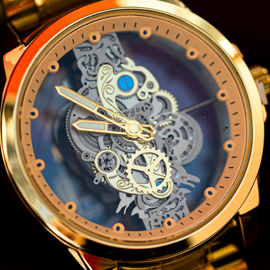 Gold wristwatch with a detailed mechanical face on a dark background