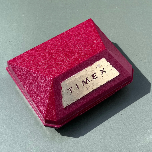 Red Timex watch box on a gray surface
