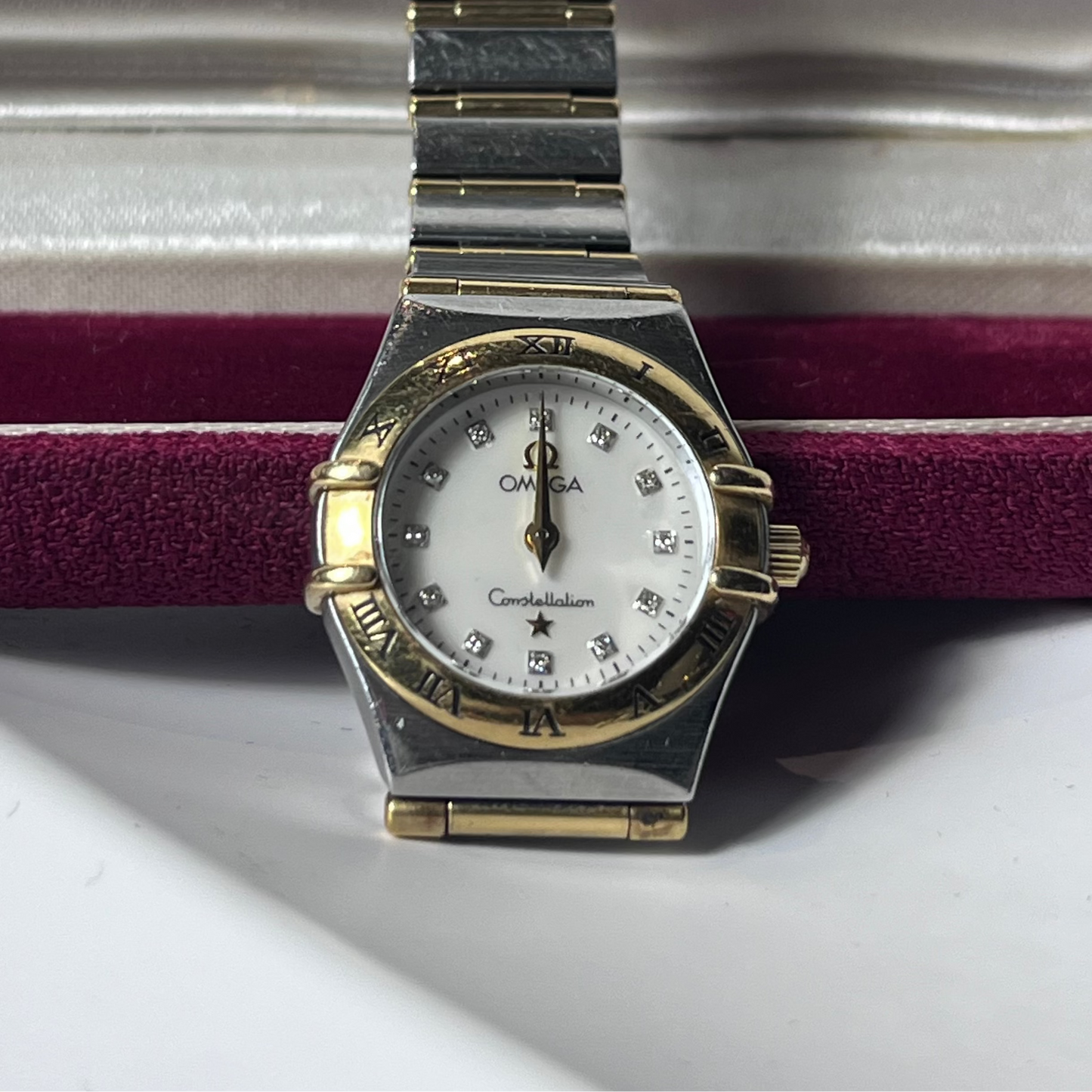 Vintage watch with a gold and silver band on a white background