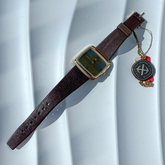 Watch with a brown strap and gold case on a white background