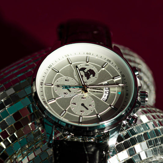 Silver watch on a disco ball with a dark background