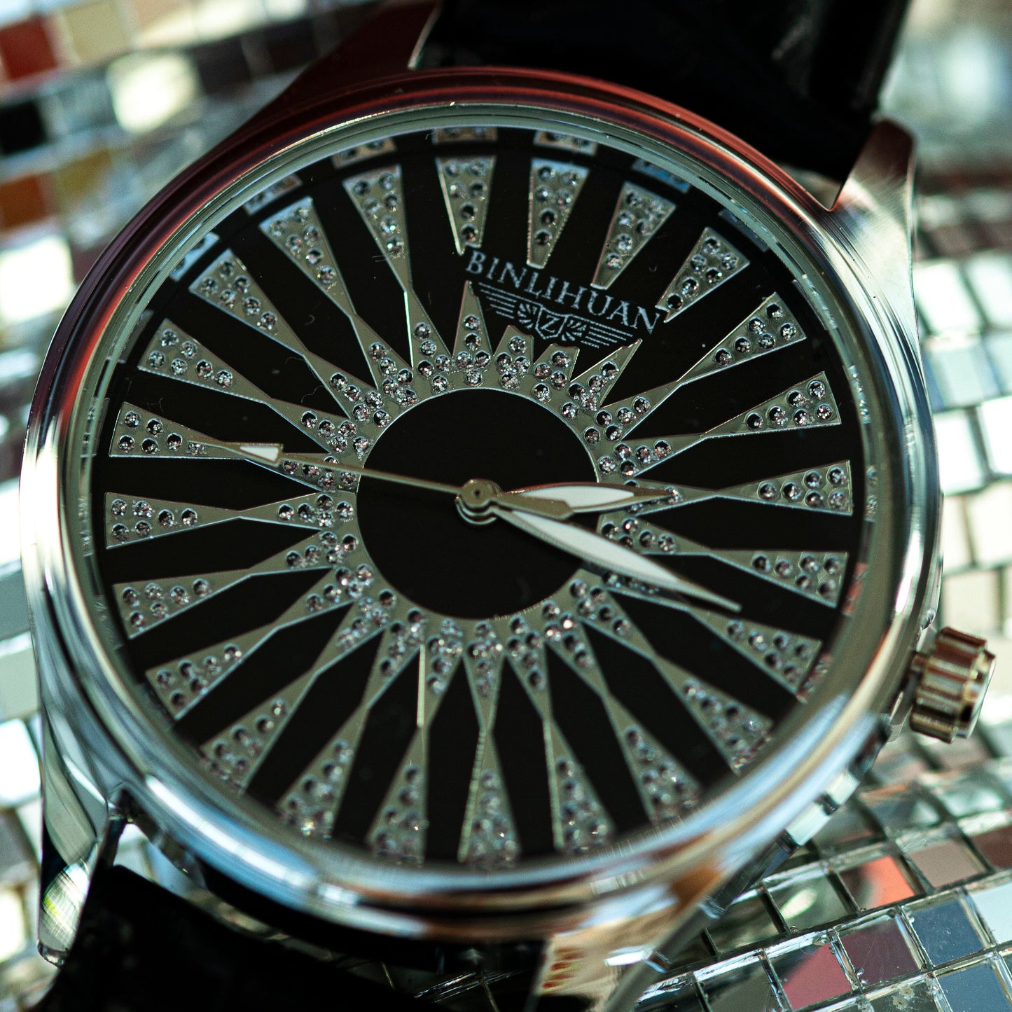 Watch with a decorative face on a reflective surface