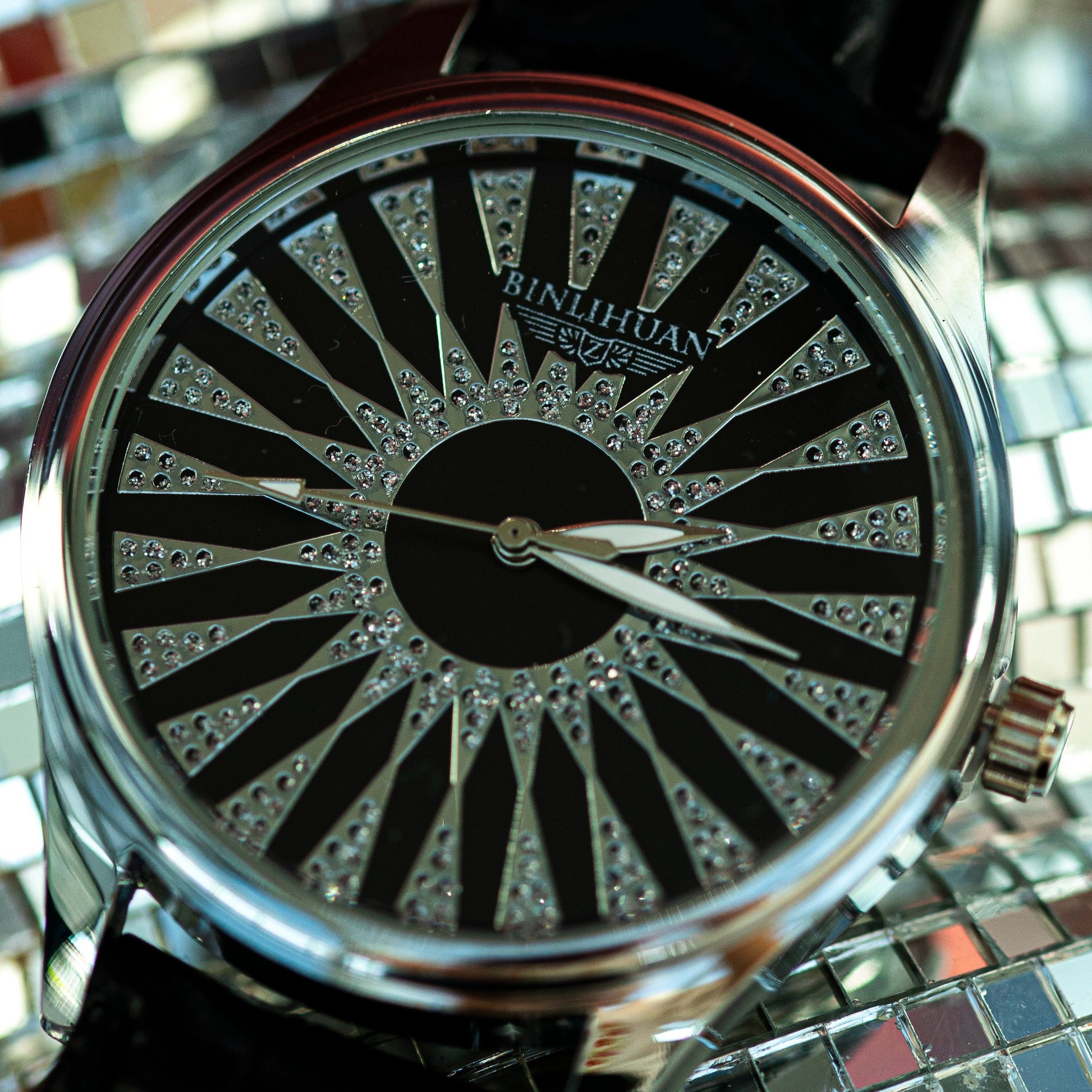 Watch with a decorative face on a reflective surface