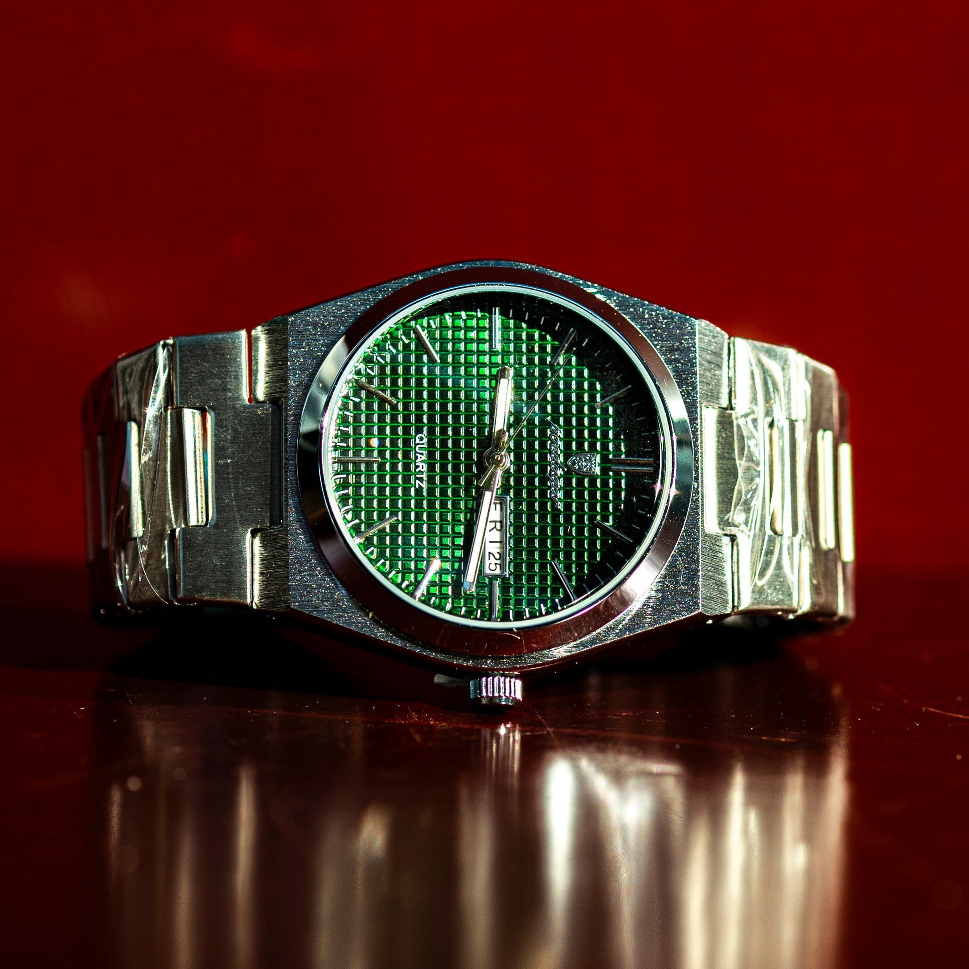 Wristwatch with green digital display on a reflective surface